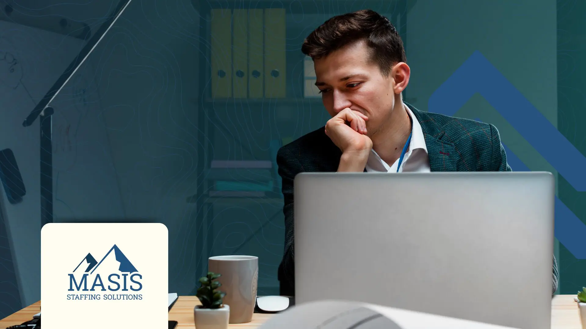 A man in front of a computer, deeply thinking.