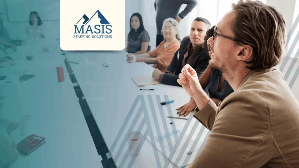 Man speaking to accounting team sitting at a conference table