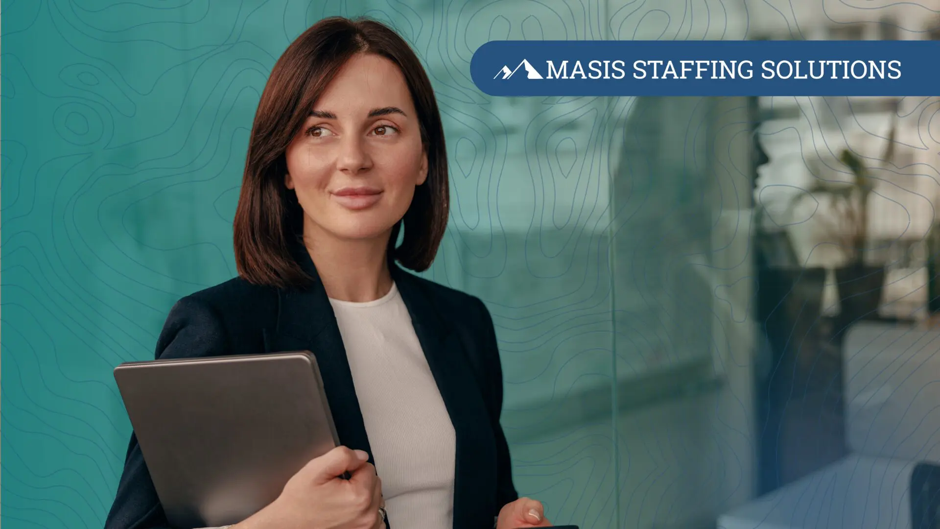 Female executive holding a mobile phone and laptop