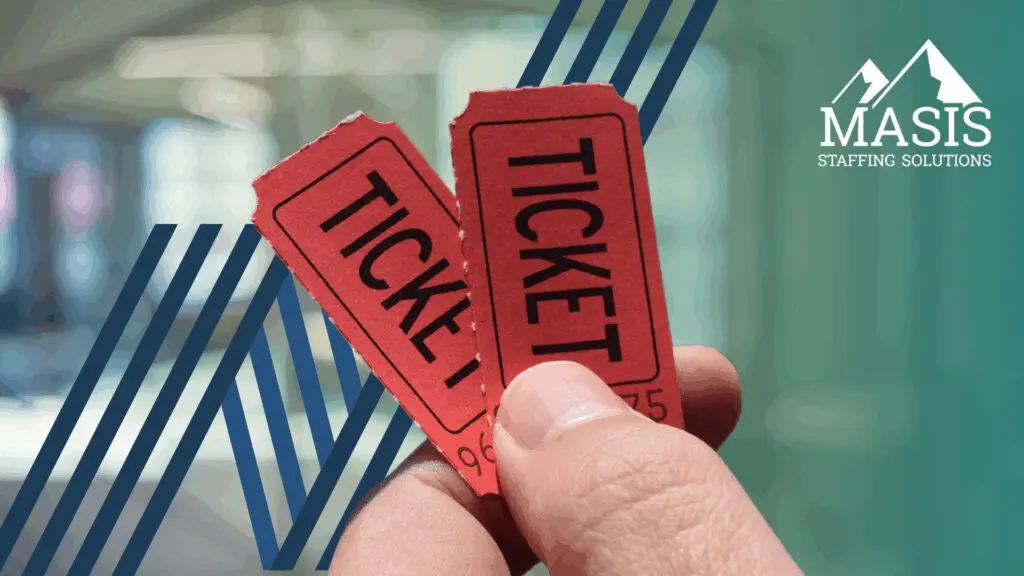 Close up of hand holding two tickets