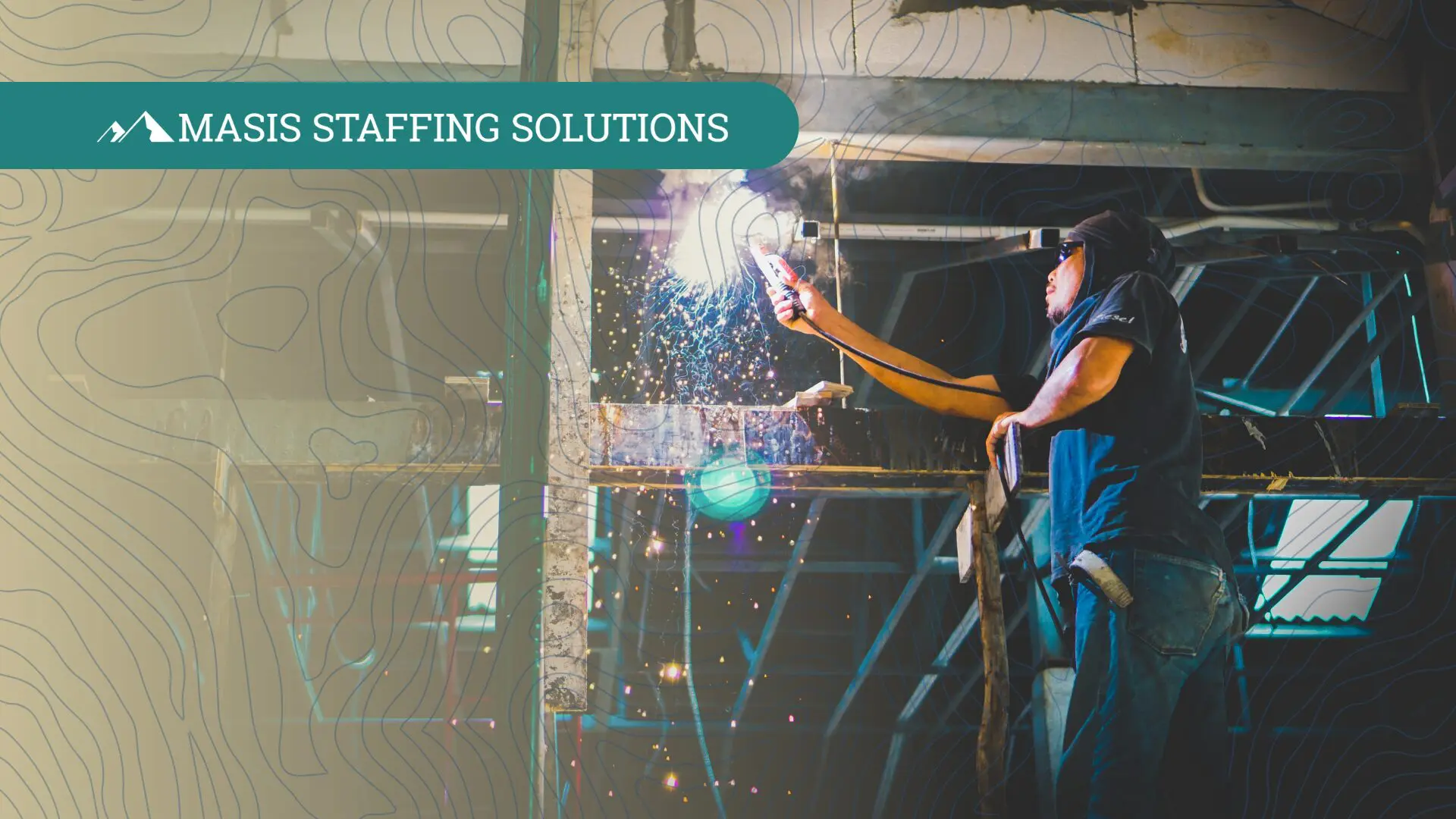 Man in protective gear welding metal