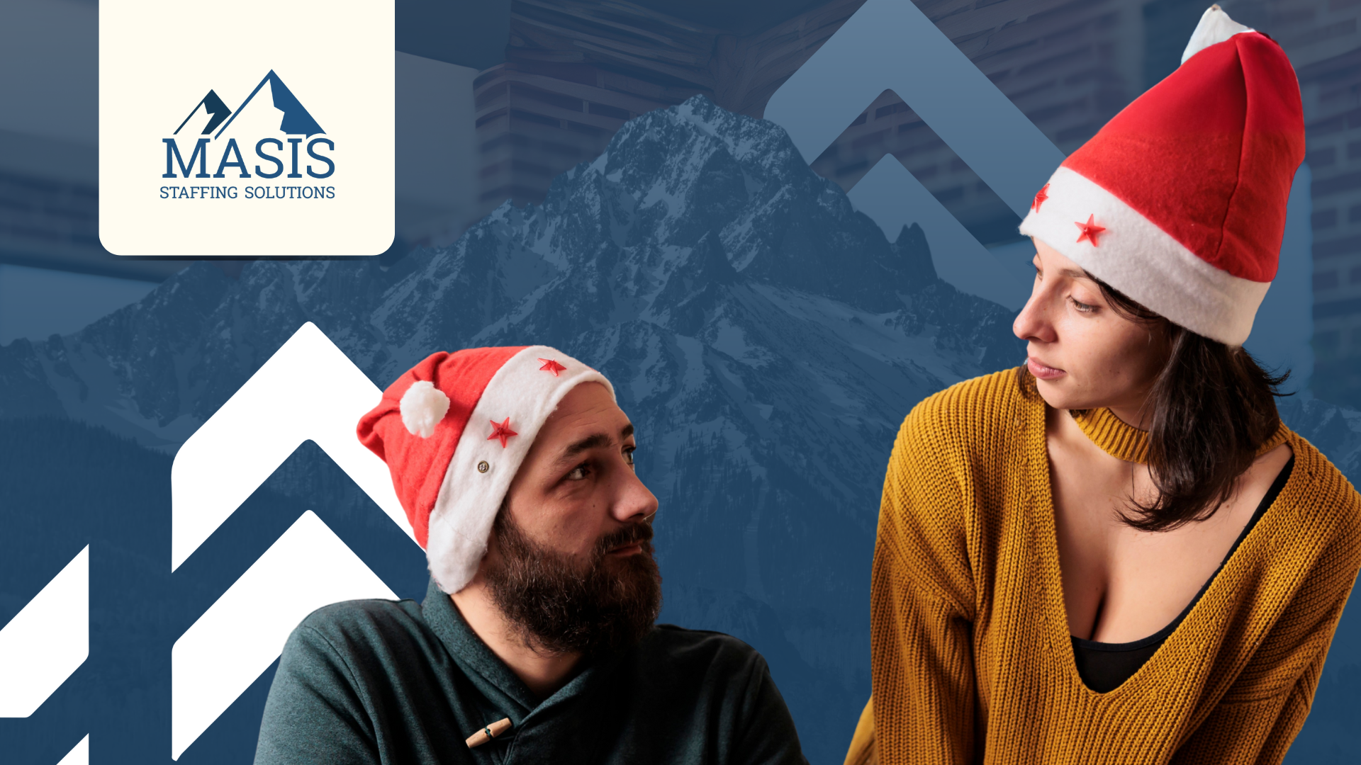 A man in a Santa hat and on his laptop looks at a female family member also in a Santa hat