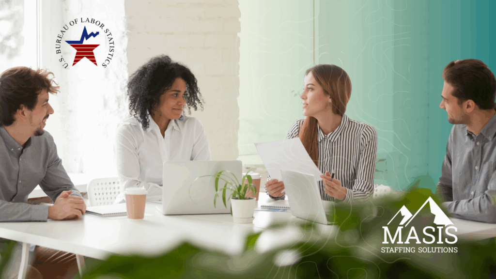 People in corporate attire meet at a table to discuss the US Bureau of Labor Statistics' 2024 report