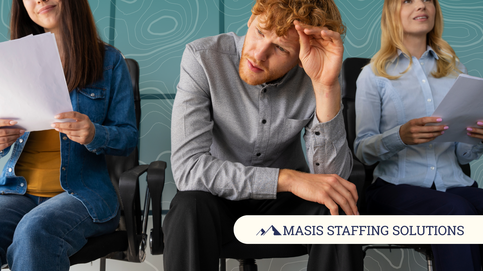 Stressed applicant in corporate attire sits between two calm women holding papers