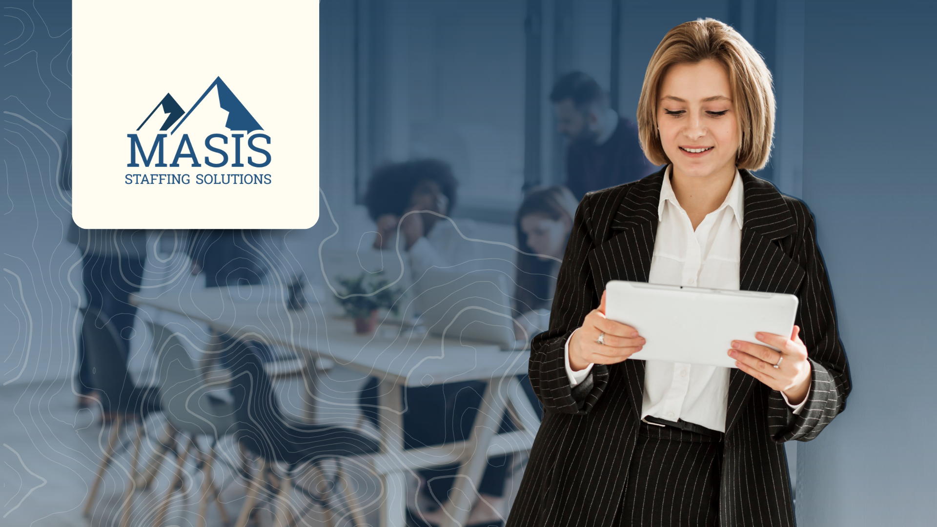 Woman in corporate attire works on a tablet, with an office setting behind her