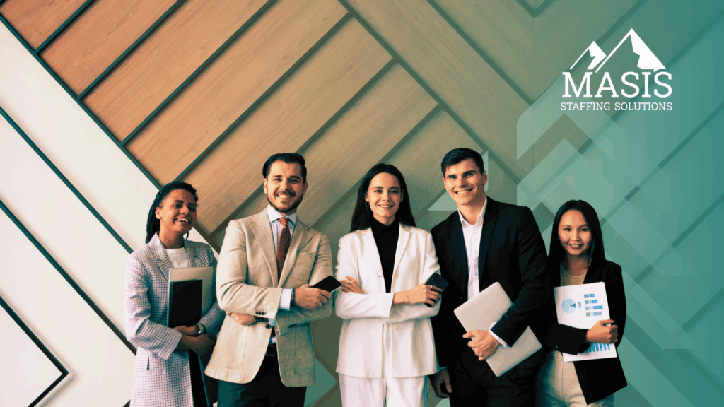 Several employees in corporate attire stand smiling side by side