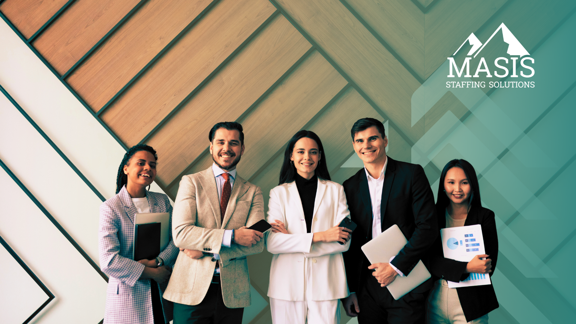 Several employees in corporate attire stand smiling side by side