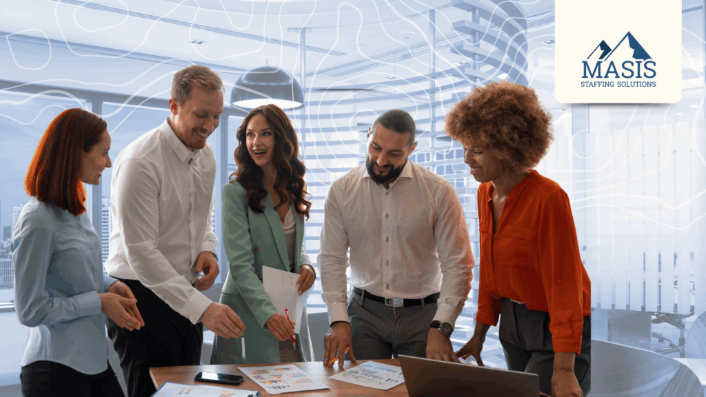 Five rapid hire employees stand at an office table