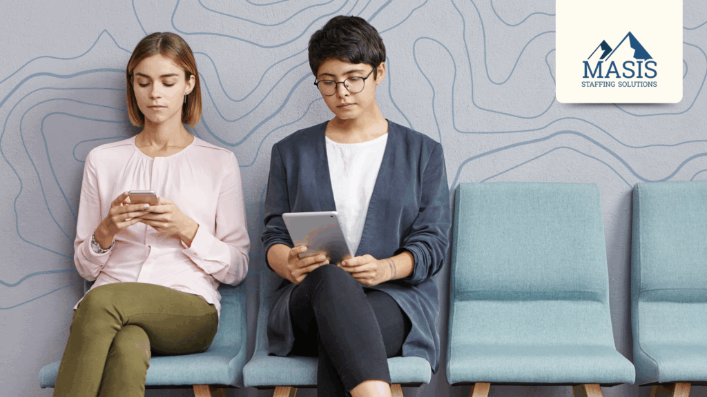 Two candidates on a holiday job search sit in a waiting area