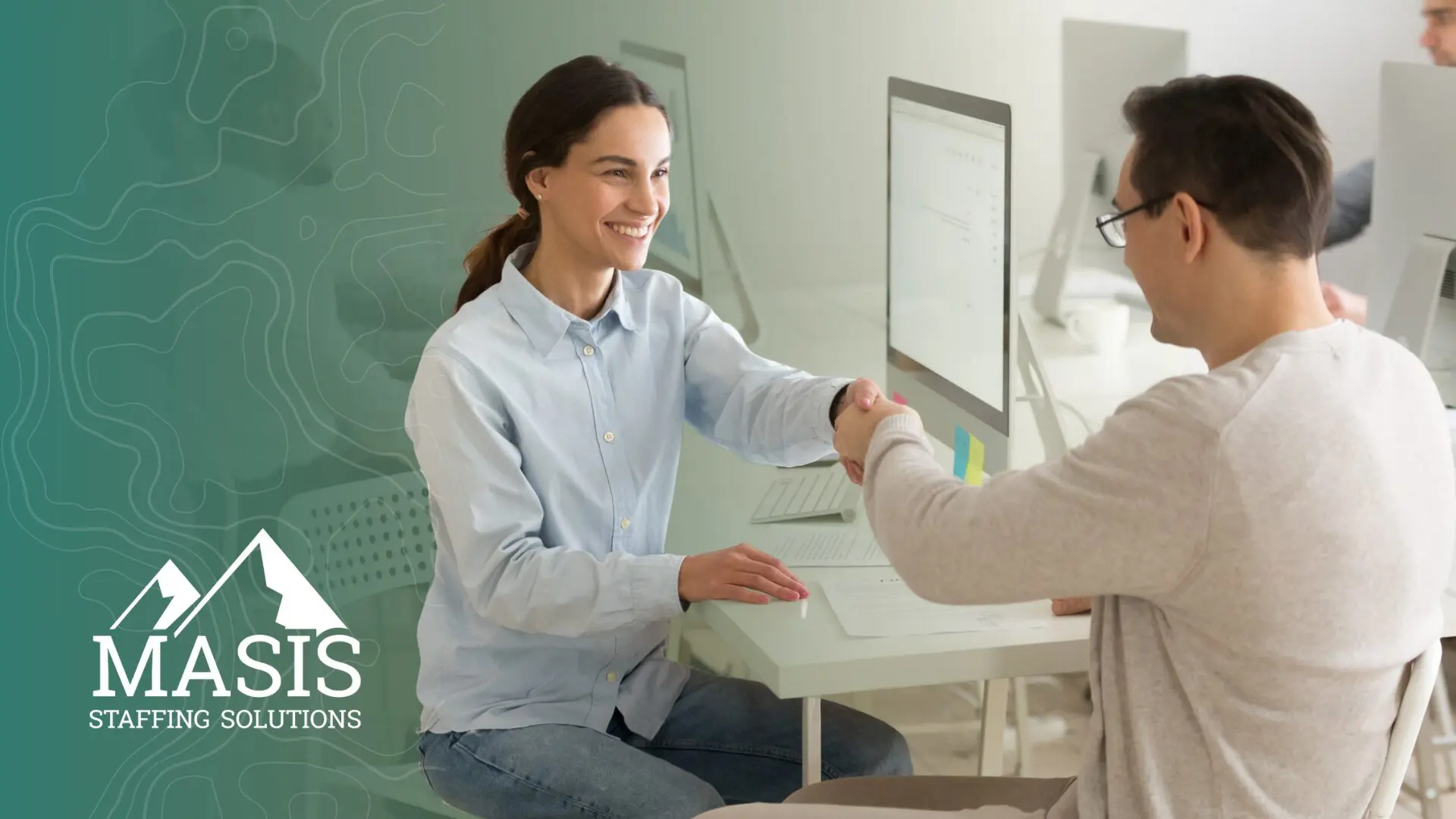 A recruiter and candidate shake hands, illustrating hiring trends