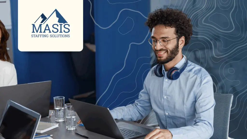 Man in business attire works at an office table