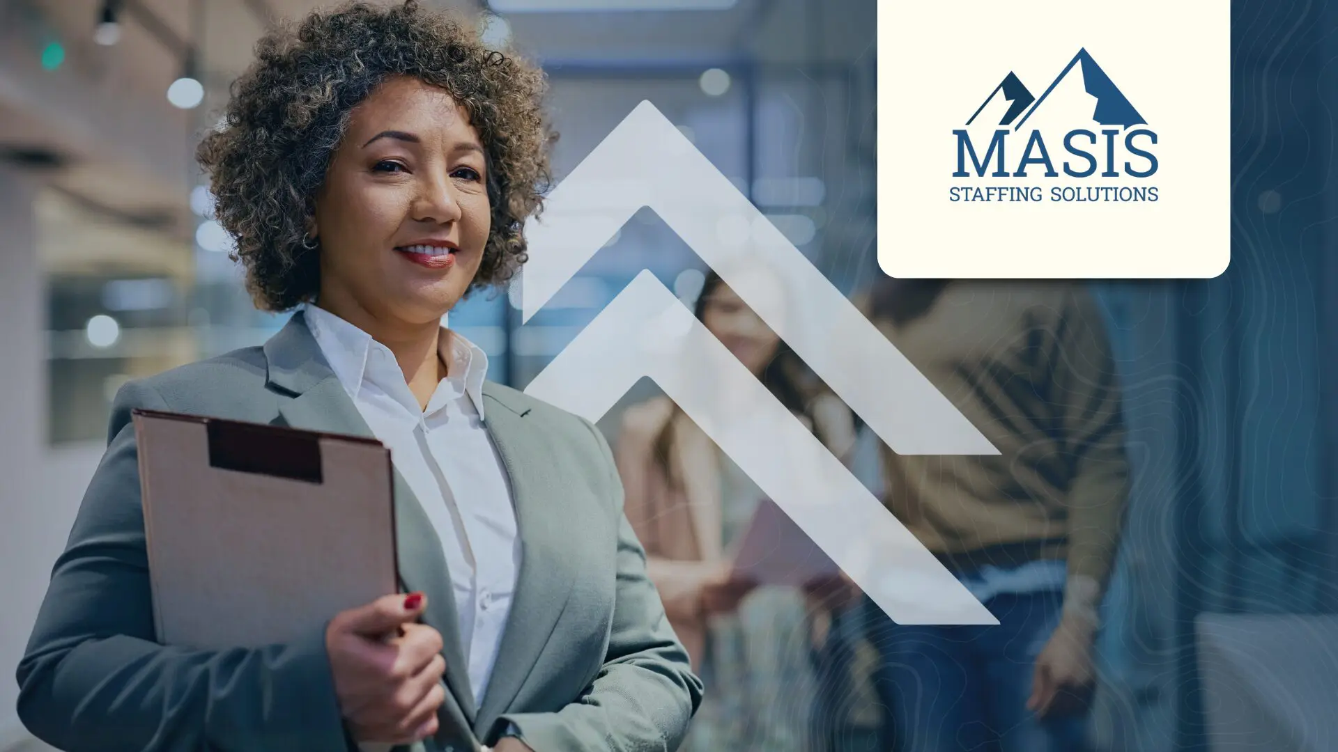 Clerical employee wearing a blazer and holding a clipboard