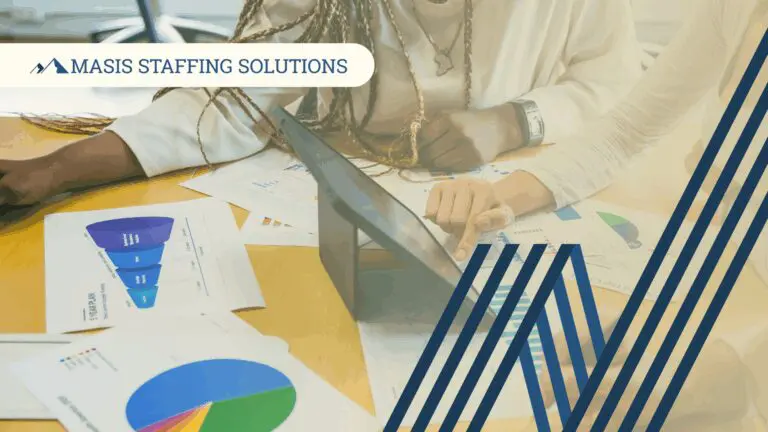 Professionals work at a table covered in papers displaying staffing analytics