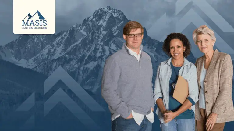 Three professionals stand confidently against a backdrop of mountain peaks that echoes Masis Staffing's mountain logo.