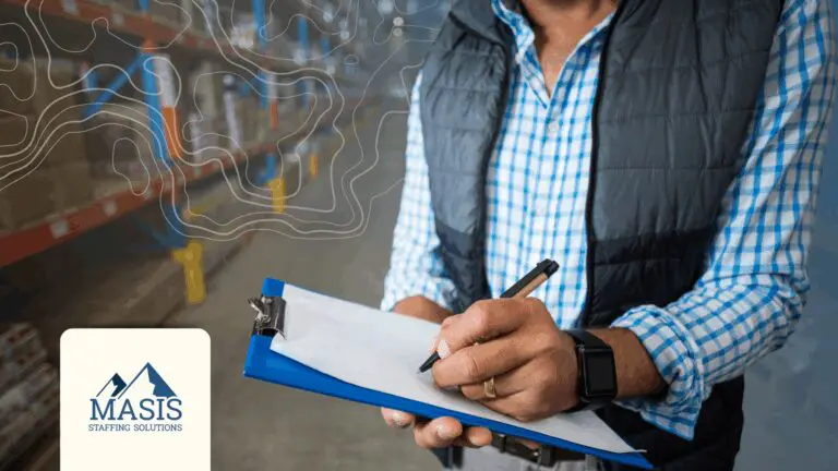 Warehouse employer holding clipboard and pen while reviewing compliance documentation in a distribution facility