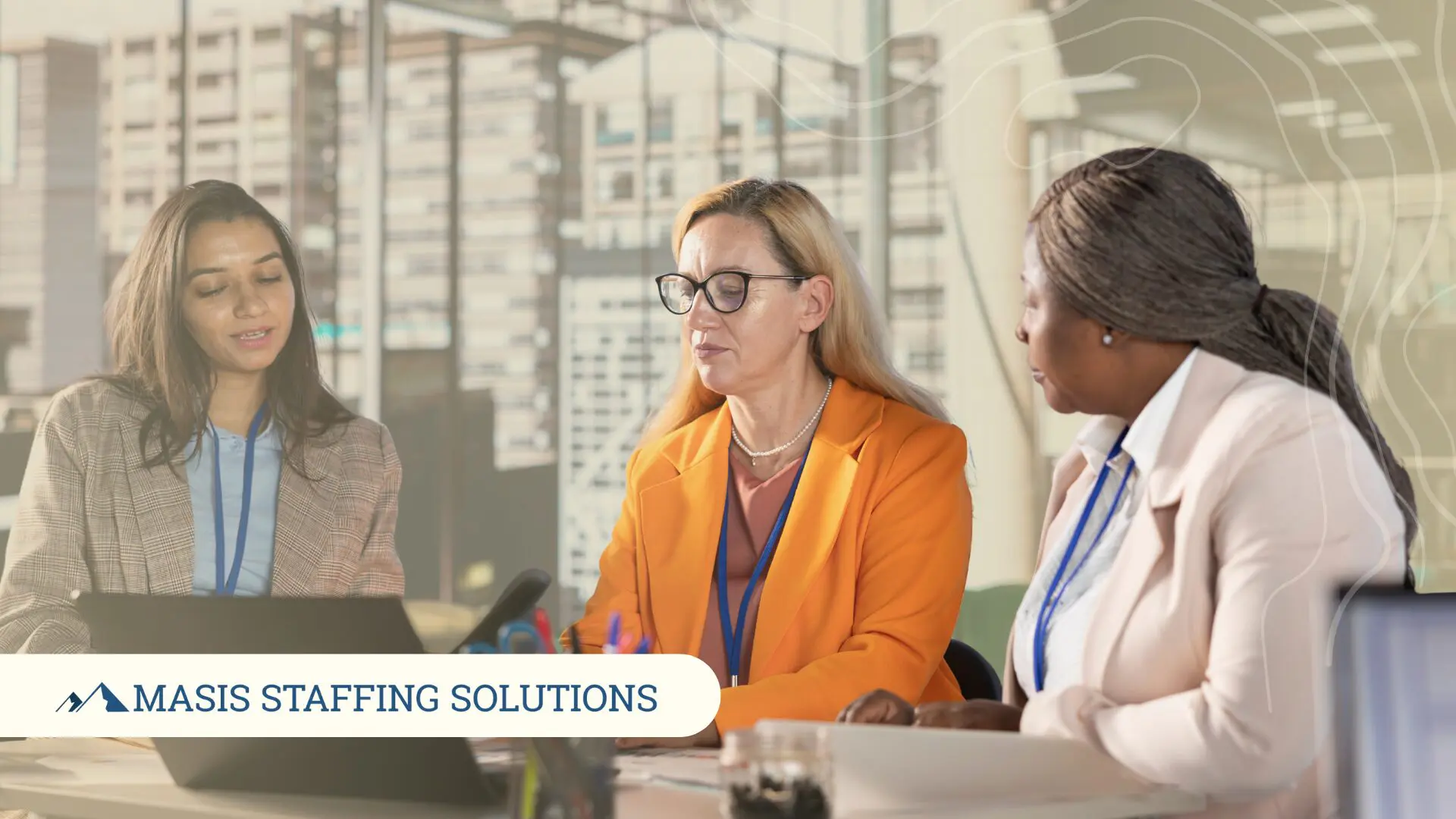 Three administrative role professionals discuss work at an office table