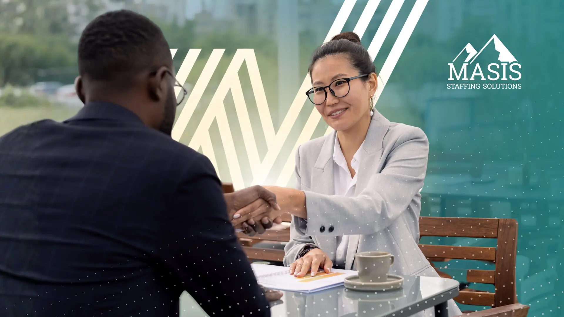 Two professionals shake hands during a professional services interview