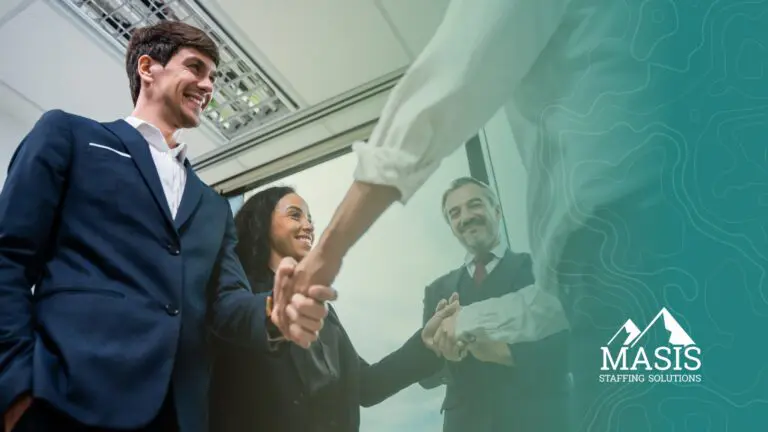 A recruiter's new hires shake hands with their new employers