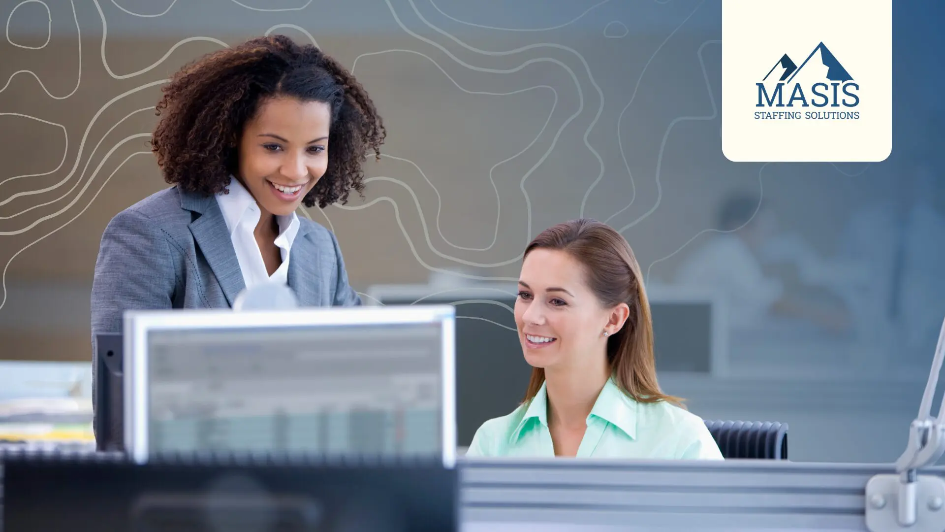 Two professionals in the clerical field talk at work