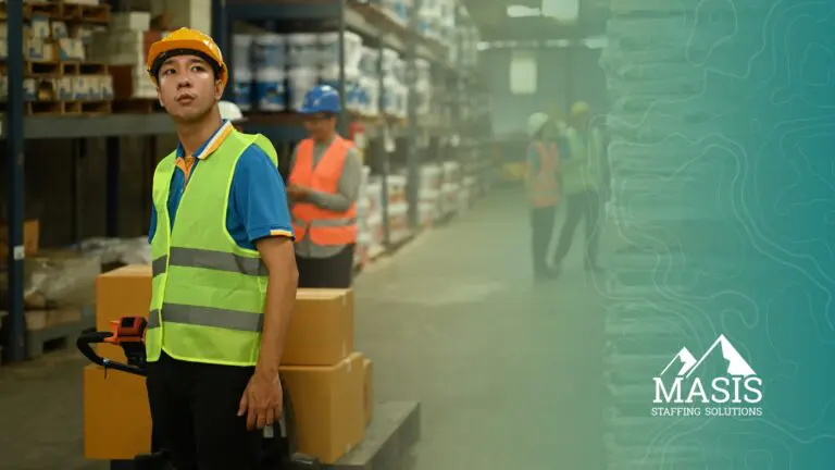 A temp-to-perm light industrial professional stands with a pallet jack in a warehouse