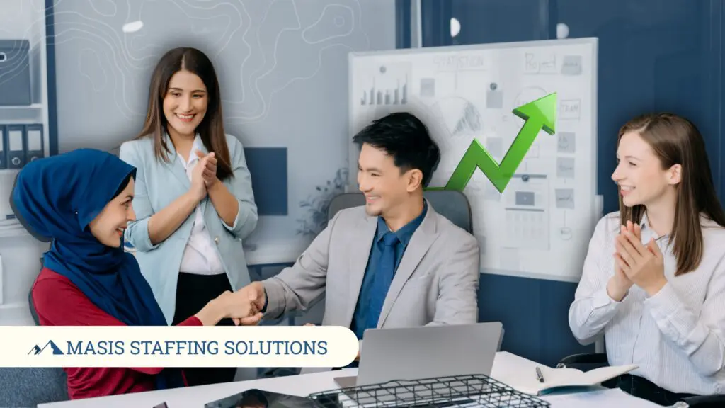 A recruiter shakes hands with a temporary employee hired as full-time staff, illustrating real temp-to-perm transitions that happen through Masis Staffing.