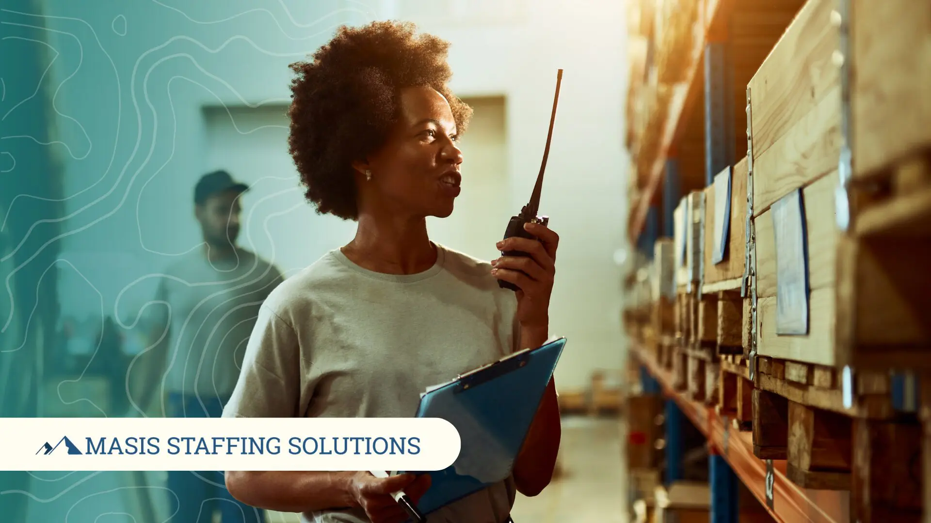 A woman in a warehouse uses a radio to coordinate with her team, illustrating the value of ongoing communication between employers and staffing partners.