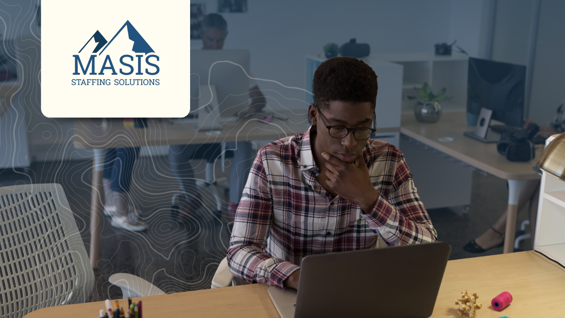 Employee works at a desk during the August slump