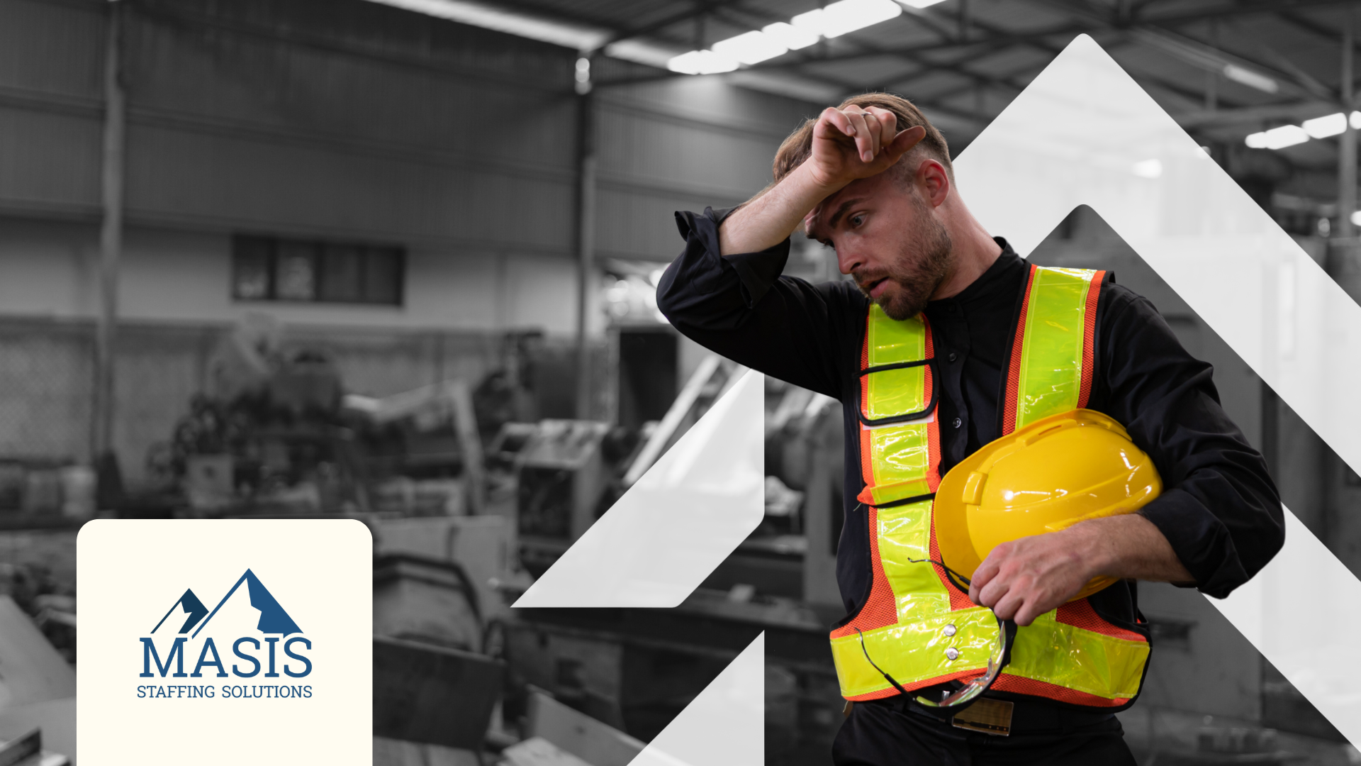 Tired supply chain worker in safety vest holds his hard hat and wipes sweat off his forehead