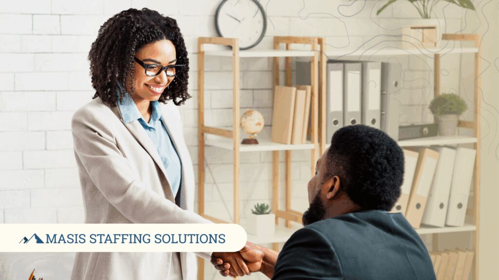 Interviewer shakes hands with successful job applicant