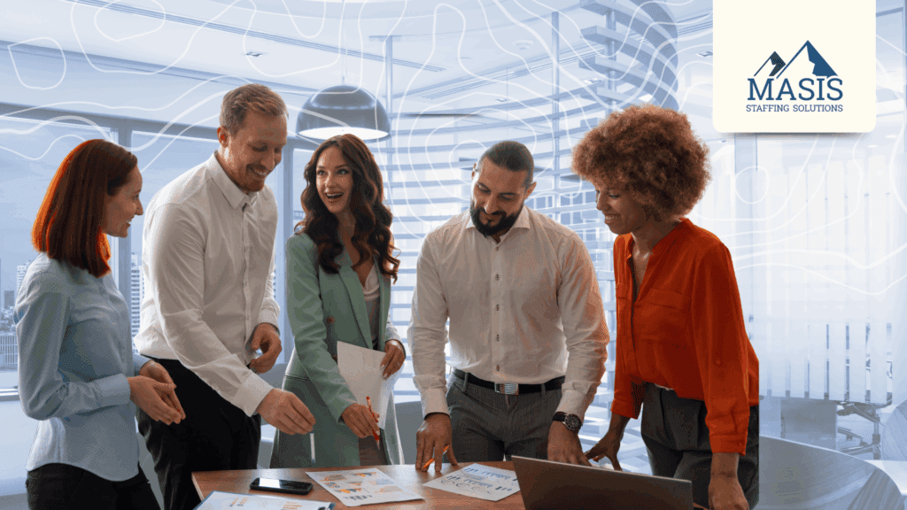 Five rapid hire employees stand at an office table