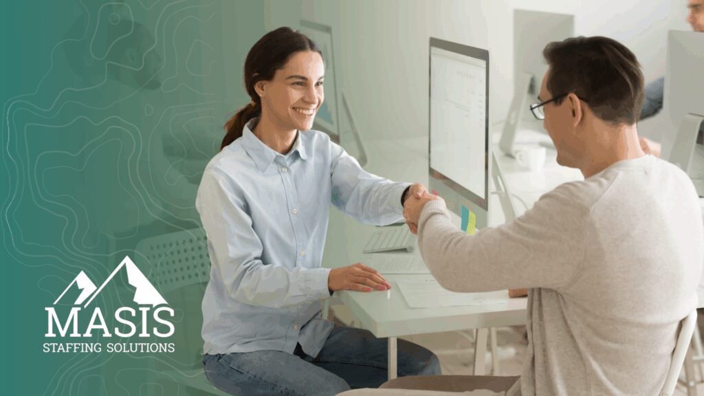 A recruiter and candidate shake hands, illustrating hiring trends