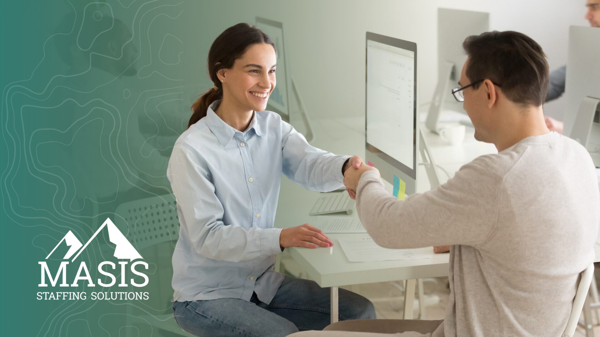 A recruiter and candidate shake hands, illustrating hiring trends