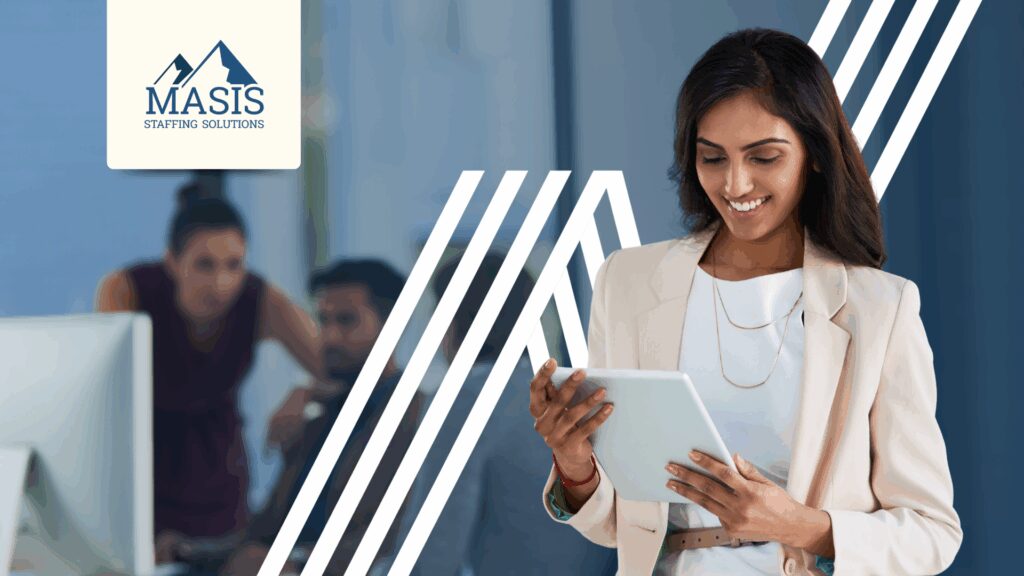Admin staff stands holding a mobile tablet in the office