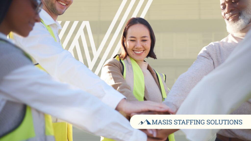 Light industrial employees put their hands together, symbolizing team loyalty in high-turnover industries