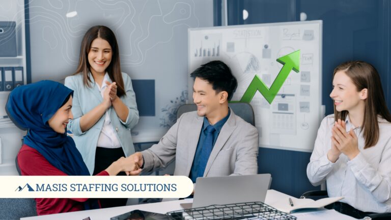 A recruiter shakes hands with a temporary employee hired as full-time staff, illustrating real temp-to-perm transitions that happen through Masis Staffing.